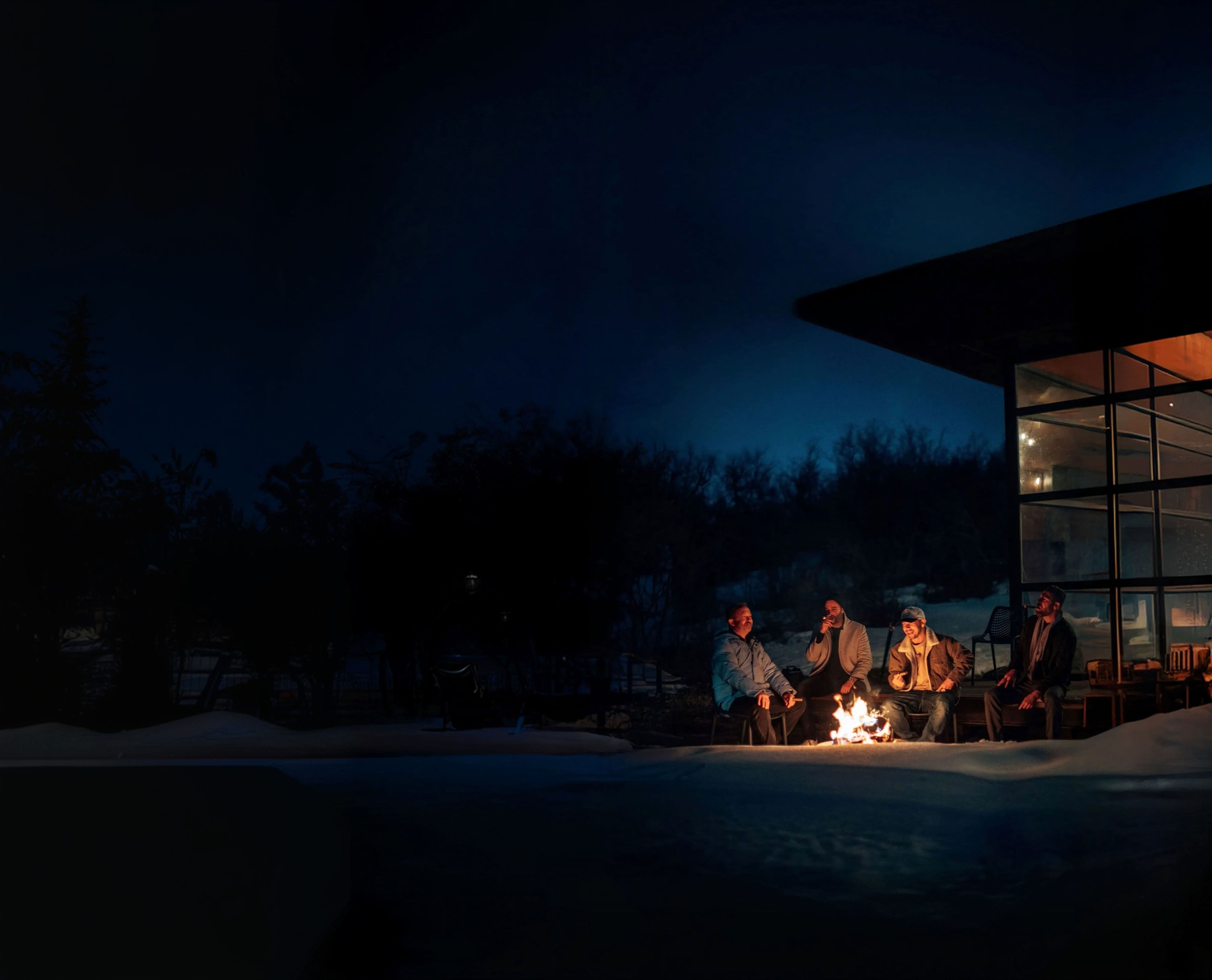 LCL brothers sharing a conversation around a fire